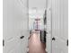 Hallway with wood floors offering views into the kitchen and featuring plenty of storage space at 221 Trillium Ave, Summerville, SC 29483