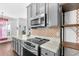 Modern kitchen featuring stainless appliances, light countertops, and decorative backsplash at 221 Trillium Ave, Summerville, SC 29483