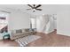 Spacious living room with hardwood floors, plush gray sofa and staircase access to the upper level at 221 Trillium Ave, Summerville, SC 29483