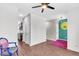 Bright living room boasts wood floors, modern ceiling fan, and unique artwork on the accent wall at 221 Trillium Ave, Summerville, SC 29483