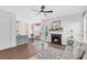 Inviting living room featuring fireplace, hardwood floors, and an adjacent kitchen at 221 Trillium Ave, Summerville, SC 29483