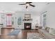 Cozy living room with a fireplace, comfortable seating, and a view of the outdoors, creating a warm and inviting space at 221 Trillium Ave, Summerville, SC 29483