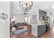 Open concept living room with modern lighting, hardwood floors, and direct access to the kitchen at 221 Trillium Ave, Summerville, SC 29483