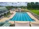 An inviting community pool with ample lounge chairs, promising relaxation and recreation for residents at 221 Trillium Ave, Summerville, SC 29483