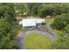 Beautiful aerial view of a charming country home with a white metal roof and a well manicured lawn at 225 Baxter Ln, Walterboro, SC 29488