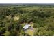 An aerial view of a lovely property with a house, barn, surrounded by lush, dense trees at 225 Baxter Ln, Walterboro, SC 29488