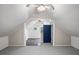 View of attic space with a door that leads to an adjacent room with window AC unit at 225 Baxter Ln, Walterboro, SC 29488