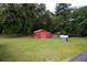 Aerial view of the red barn with crossbuck doors plus gazebo in a spacious yard with mature trees at 225 Baxter Ln, Walterboro, SC 29488