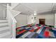 Finished basement with colorful patchwork carpet, decorative fireplace, and access to the backyard at 225 Baxter Ln, Walterboro, SC 29488