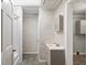 Bathroom featuring patterned wallpaper, vinyl floors, and shower with curtain at 225 Baxter Ln, Walterboro, SC 29488