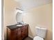 The bathroom features a wood vanity with dark countertop and a commode at 225 Baxter Ln, Walterboro, SC 29488