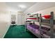 A bedroom with bunk beds, green carpet, a closet, and a desk at 225 Baxter Ln, Walterboro, SC 29488