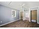 A bedroom with gray walls, ceiling fan, wood floor, window and closet at 225 Baxter Ln, Walterboro, SC 29488