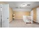 Bonus room features neutral carpet, painted walls, and a staircase with white railing at 225 Baxter Ln, Walterboro, SC 29488