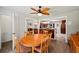 Dining room featuring a ceiling fan, an oval dining table, and view to kitchen bar at 225 Baxter Ln, Walterboro, SC 29488