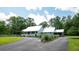 Charming single-story home with a long driveway, metal roof, beautiful landscaping, and inviting porch at 225 Baxter Ln, Walterboro, SC 29488