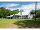 View of the home, showcasing its gray siding, metal roof, covered porch and second story deck at 225 Baxter Ln, Walterboro, SC 29488