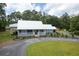 A beautifully landscaped yard leads to a charming home with a inviting porch, perfect for relaxing at 225 Baxter Ln, Walterboro, SC 29488