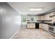 A kitchen featuring light gray cabinets and stainless steel appliances next to a large, sunlit window at 225 Baxter Ln, Walterboro, SC 29488