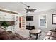 Cozy living room featuring a ceiling fan, decorative shelving, and comfortable leather seating at 225 Baxter Ln, Walterboro, SC 29488