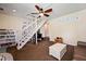 A charming living room with wooden stairs, neutral colored carpet, and an attached study at 225 Baxter Ln, Walterboro, SC 29488