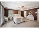 A main bedroom featuring dark brown walls, a white wicker bedroom set, and two windows for natural light at 225 Baxter Ln, Walterboro, SC 29488