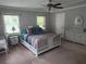 A bright main bedroom featuring a wicker bed set, ceiling fan, and two windows providing plenty of natural light at 225 Baxter Ln, Walterboro, SC 29488