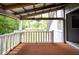 An outdoor porch featuring brown floor boards, a sink, and white railings at 225 Baxter Ln, Walterboro, SC 29488