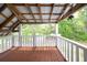 A back porch with a sink, brown floor boards, and white railings at 225 Baxter Ln, Walterboro, SC 29488
