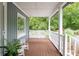 Relaxing porch with wooden floors, a swing, and a view of the surrounding greenery at 225 Baxter Ln, Walterboro, SC 29488