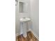 Bathroom features a pedestal sink and wood-look flooring at 260 Sweet Cherry Ln, Summerville, SC 29486