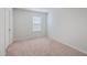 A well-lit bedroom with neutral carpet, a window with blinds, and a closet door at 260 Sweet Cherry Ln, Summerville, SC 29486