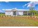 Beautiful white clubhouse with metal roof, picnic tables, and manicured landscaping at 260 Sweet Cherry Ln, Summerville, SC 29486