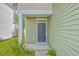 A close-up of the light green home's front door with a small porch and matching trim at 260 Sweet Cherry Ln, Summerville, SC 29486