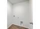 This spacious laundry room features sleek wood-look floors and convenient hookups for modern appliances at 260 Sweet Cherry Ln, Summerville, SC 29486