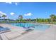 A beautiful community swimming pool with lounge chairs, palm trees, and sunny blue skies at 260 Sweet Cherry Ln, Summerville, SC 29486