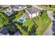 Aerial view of backyard with a custom pool, manicured lawn, fenced yard, and home with screened porch at 3011 River Vista Way, Mount Pleasant, SC 29466