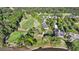 Beautiful aerial view of a neighborhood featuring lush green golf courses, stately homes, and mature trees at 3011 River Vista Way, Mount Pleasant, SC 29466