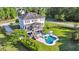 Aerial view of home with a screened porch, beautiful pool, surrounding foliage, and large green lawn at 3011 River Vista Way, Mount Pleasant, SC 29466