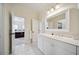 Bathroom with white cabinetry and mirror offering an open doorway view of a bedroom at 3011 River Vista Way, Mount Pleasant, SC 29466