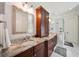Bathroom featuring double sinks, granite countertop, vanity, mirrors, and a glass shower at 3011 River Vista Way, Mount Pleasant, SC 29466