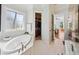 Bathroom area with a soaking tub next to a window and a closet nearby at 3011 River Vista Way, Mount Pleasant, SC 29466