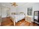 Light and airy bedroom featuring hardwood floors and a decorative ceiling fan at 3011 River Vista Way, Mount Pleasant, SC 29466