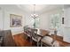 Dining room featuring a wooden table, six chairs, plantation shutters, and custom trim at 3011 River Vista Way, Mount Pleasant, SC 29466