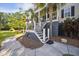 Stairs with railings leading to the double front porch, landscaping, and home's address at 3011 River Vista Way, Mount Pleasant, SC 29466