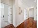 Hallway featuring hardwood floors and white trim with doors to different rooms of the house at 3011 River Vista Way, Mount Pleasant, SC 29466