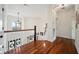 Upstairs hallway featuring hardwood floors, decorative lighting, and a view of the staircase at 3011 River Vista Way, Mount Pleasant, SC 29466
