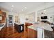 Open-concept kitchen with marble countertops, center island, and seamless connection to the living room at 3011 River Vista Way, Mount Pleasant, SC 29466