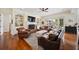 Cozy living room with leather furniture, fireplace, built-in shelves, and access to the outdoor patio at 3011 River Vista Way, Mount Pleasant, SC 29466