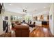 Open concept living room with brick fireplace, leather sofas, and seamless transition to the kitchen at 3011 River Vista Way, Mount Pleasant, SC 29466